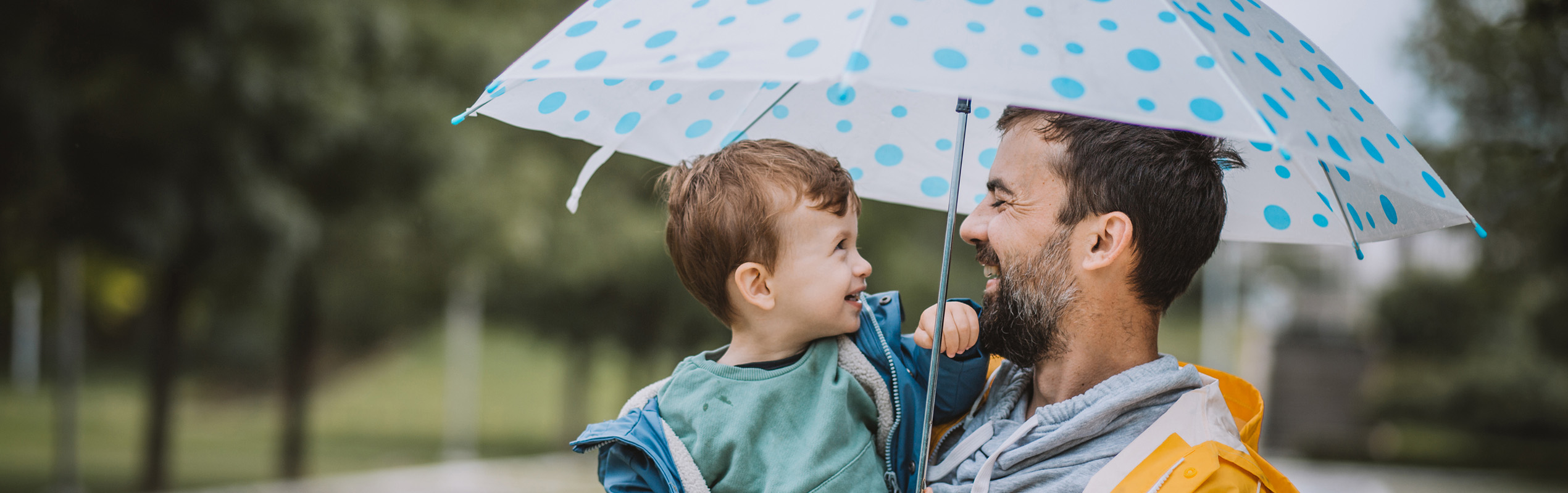 father and son with umbrella