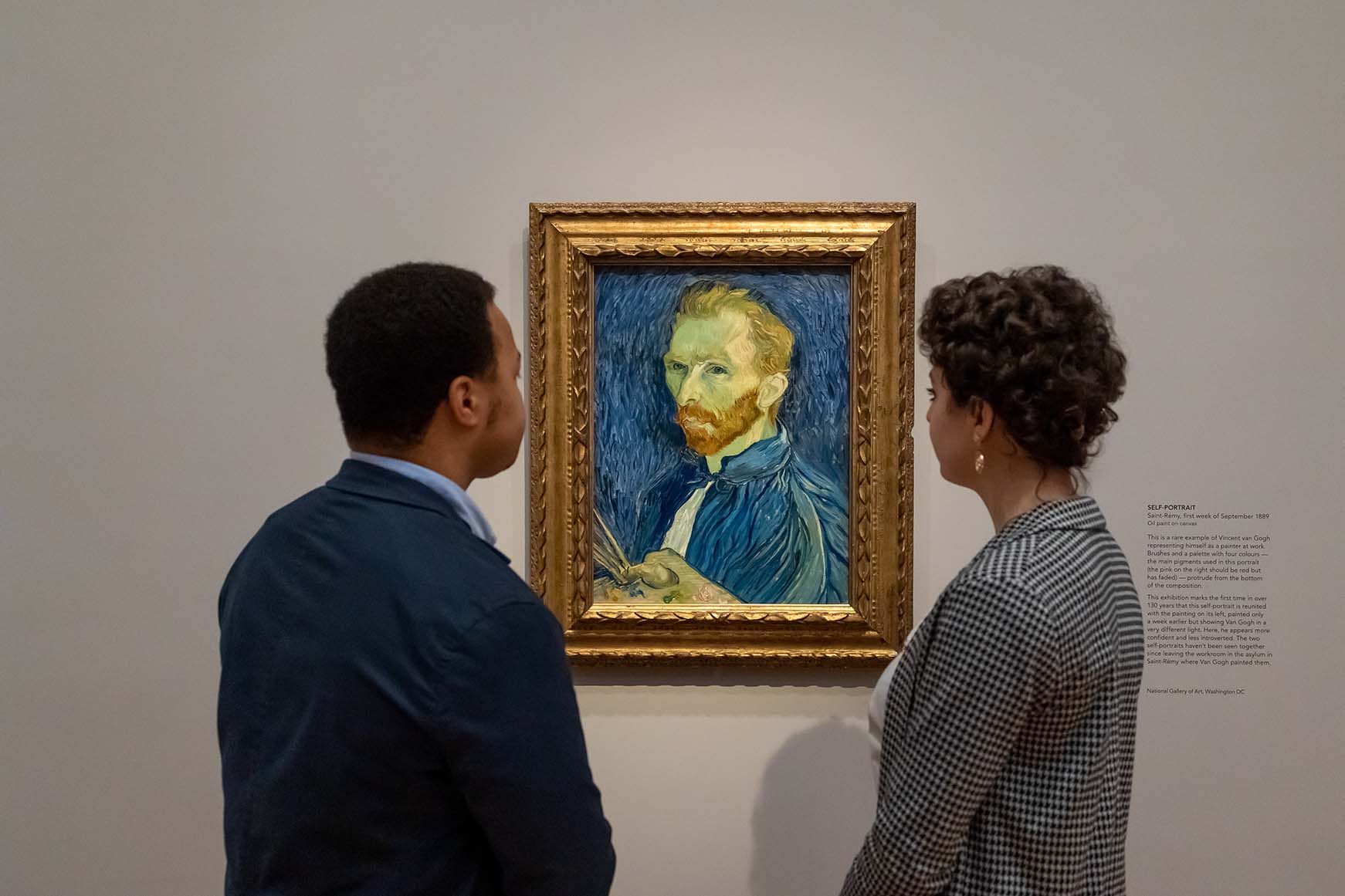 Gallery visitors looking at self-portrait by Vincent van Gogh